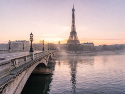Scenic Parisian bridge overlooking the Eiffel Tower and Seine river at dawn